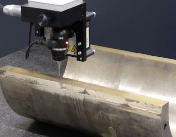 Hybrid CMM with a touch-trigger and a laser probe measuring the contour method cut surface of a pipe.