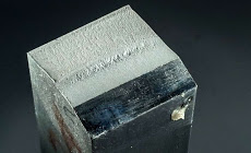 Photography of post-test metal matrix composite test specimen with a plain-strain fracture and a fatigue crack.