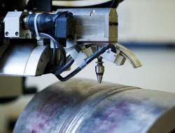 Photography of an x-ray diffractometer (XRD) set up to measure residual stresses in a welded pipe.
